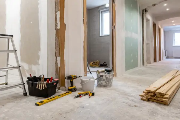 Interior refurbishment workspace with tools and materials for building maintenance and multi-trade repair work, no people